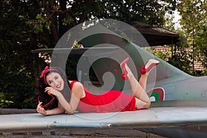 Pin-up model on airplane wing