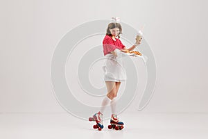 Pin Up style portrait of beautiful young girl in image of retro cater waiter wearing 70s, 80s fashion style uniform and