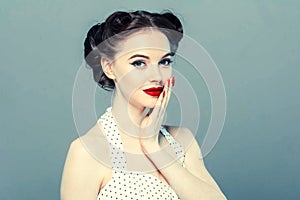 Pin up woman portrait. Beautiful retro female in polka dot dress with red lips