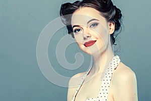 Pin up woman portrait. Beautiful retro female in polka dot dress with red lips