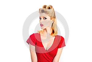 Pin up woman portrait. Beautiful retro female with red lips and old fashion hairstyle. Caucasian blond model posing in