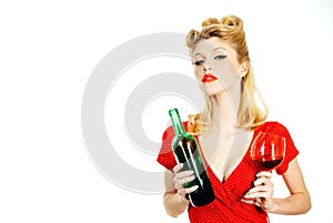 Pin up woman in red dress holding glass of red wine isolated over white background,