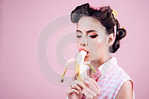 Pin up woman with trendy makeup. retro woman eating banana. pinup girl with fashion hair. pretty girl in vintage style