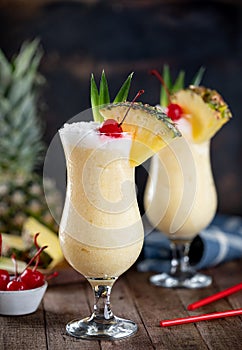 Pina colada cocktail with cherry, pineapple and leaves photo