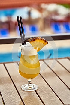 Pina colada cocktail on table outdoor in summer