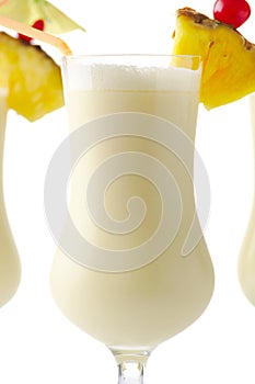 Pina colada coconut cocktail with ice on white background