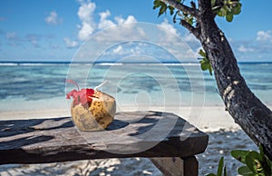 Pina colada in coconut on the tropical beach, Seychelles