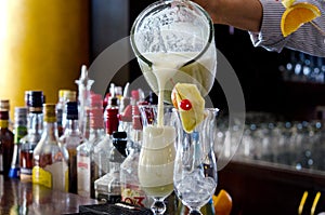 Pina Colada, exotic Cocktail ready to serve and is poured into a glass