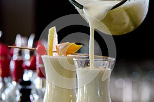 Pina Colada, exotic Cocktail ready to serve and is poured into a glass