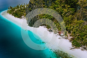 Pinagbuyutan Island, El Nido, Palawan, Philippines. Aerial drone photo of tropical hut surrounded by rocks, white sandy