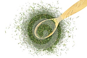 A pinch of dried herbs fennel in a wooden spoon