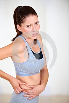 Pinch, stomach and portrait of woman for fitness, exercise and workout to lose weight. Worry, sad and person holding