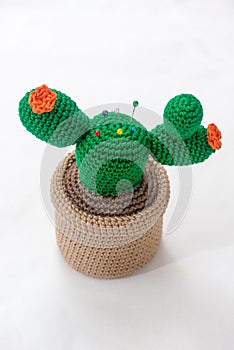 pincushion in the shape of a cactus in a pot.