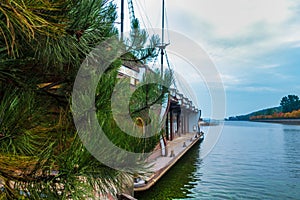 Pine branches on the background of a decorative wooden ship