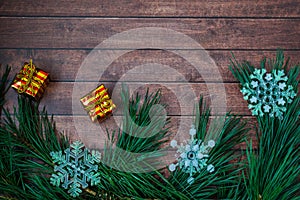 Pine branches and Christmas decorations on wooden background