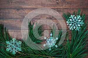 Pine branches and Christmas decorations on wooden background