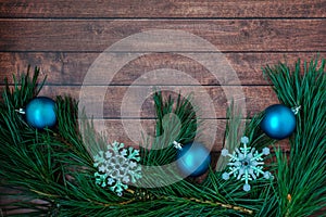 Pine branches and Christmas decorations on wooden background