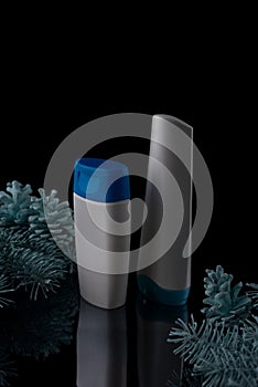 pine christmas shampoo. White shampoo bottle with spruce and cones on a black background