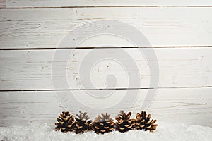 Pine cone decoration on fake snow