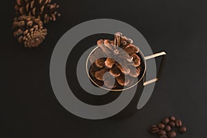 Pine cone in metal cupï¼Œ with a background of coffee beans