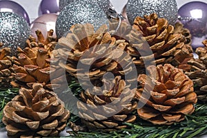 Pine cones with christmas bobbles behind