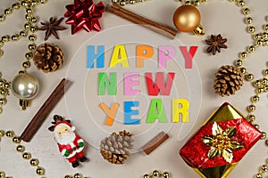 Pine cones, cinnamon sticks, star anise, pearl tinsel, Santa Claus figurine and happy new year