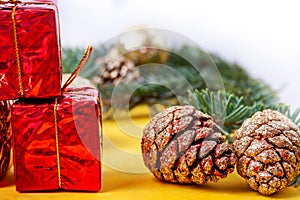 Pine cones covered with sparkles, red boxes on the table