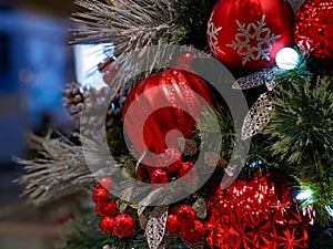 Pine cones, snowflakes, peppermints, and other ornaments decorating a Christmas tree