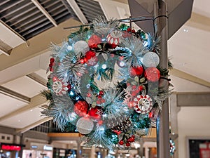 Pine cones, snowflakes, peppermints, and other ornaments decorating a Christmas wreath