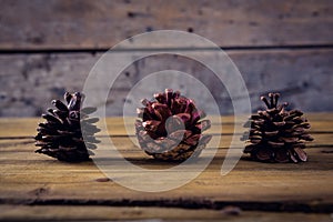 Pine cones on wooden plank