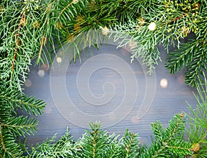 Pine and fir tree branches frame on wooden background. Merry Christmas and Happy New Year greeting card