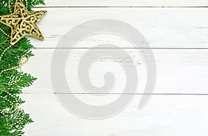 The Pine leaf with yellow gold star and christmas ball decoration on white wooden board with copy space , happy new year and chist
