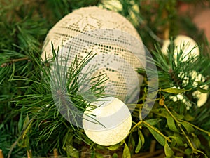 Pine and mistletoe decoration. White baubles, green branches.