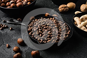 Pine nuts, on black dark stone table background