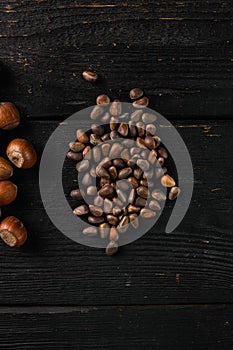 Pine nuts, on black wooden table background, top view flat lay, with copy space for text