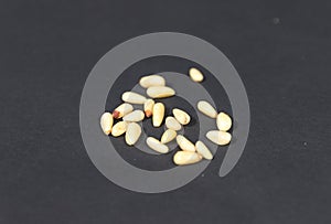 Pine nuts isolated on black background