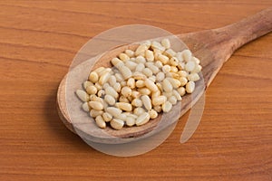 Pine nuts into a spoon