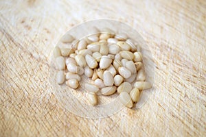 Pine nuts on wooden surface