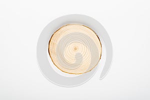 Pine tree cross-section with annual rings on white background. Lumber piece close-up, top view, isolated.