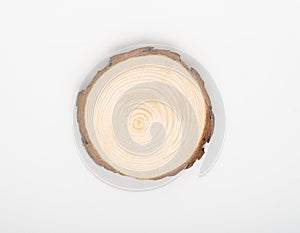 Pine tree cross-section with annual rings on white background. Lumber piece close-up, top view, isolated.
