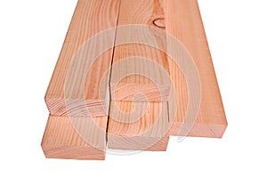Pine wood processed into several planks are stacked isolate on white background