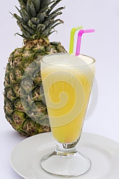 Pineaple juice with fresh pineapple isolated on white. Picture taken in Peru.