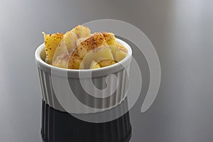 Pineapple in a bowl with chili and salt