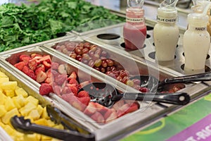 Pineapple chunks, strawberry, red grape with ranch, blue cheese, pomegranate dressing at salad bar