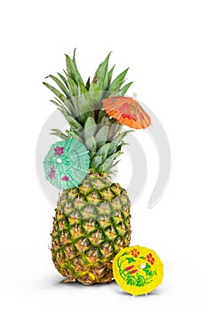 Pineapple with cocktail umbrellas isolated on white background.