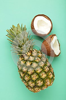 Pineapple with coconut on mint background. Tropical fruit