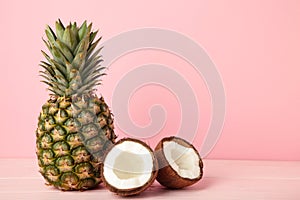 Pineapple with coconut on pink background. Tropical fruit