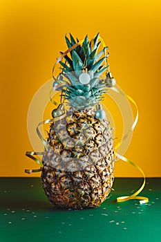 Pineapple decorated with serpentine and balls, holidays christmas and new year concept