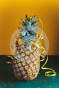 Pineapple decorated with serpentine and balls, holidays christmas and new year concept