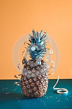 Pineapple decorated with serpentine and balls, holidays christmas and new year concept